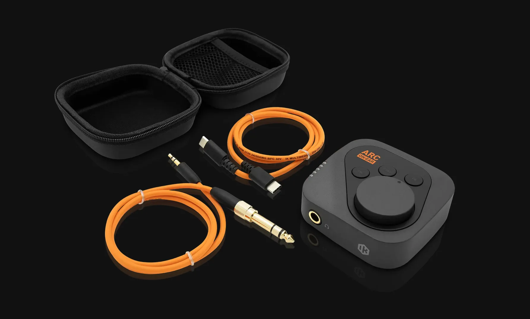 ARC audio interface with orange cables and black carrying cases displayed against dark background