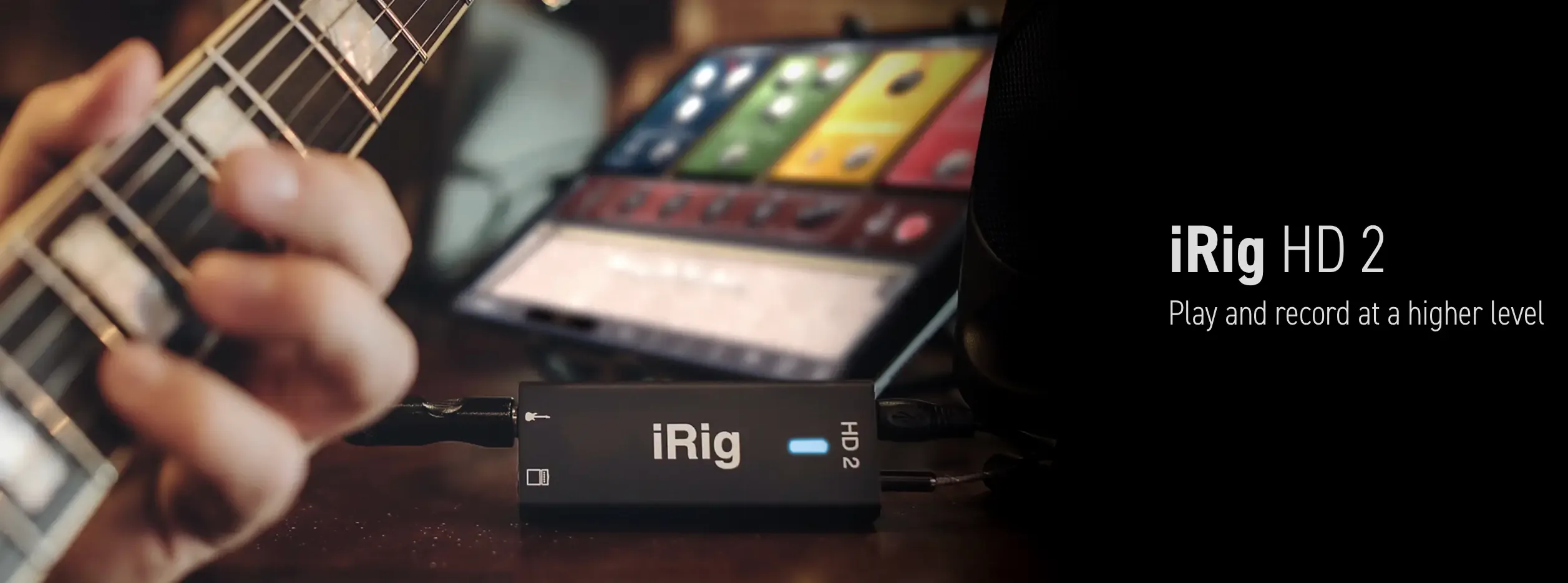 iRig HD2 interface connected to guitar, displayed alongside iPad showing audio app with colored controls