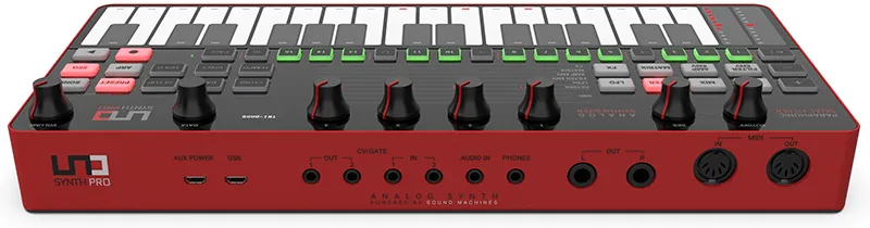 Red Uno Synth Pro desktop synthesizer with white keys, dark knobs and controls, viewed from above at an angle
