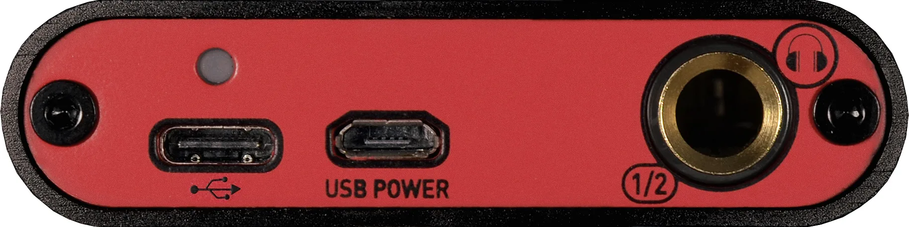 Red audio interface top panel showing USB ports, power connector, and gold 1/4-inch jack inputs against black edges