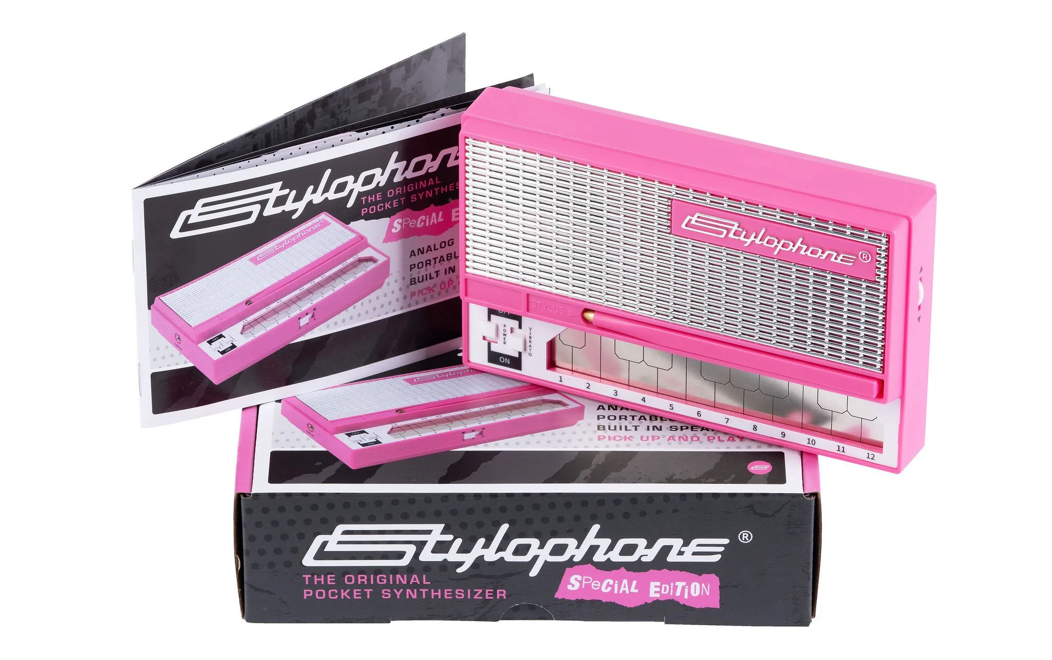 Stylophone Special Edition pink pocket synthesizer displayed open with keyboard visible, alongside black packaging box