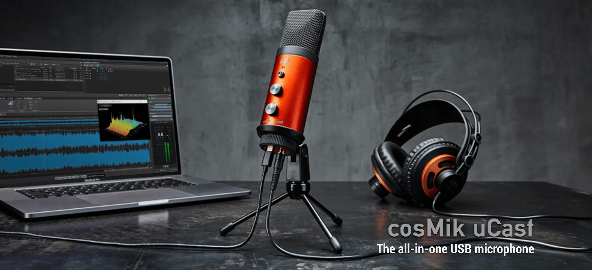 Red and grey ESI cosMik uCast USB microphone on tripod stand with orange and black headphones and laptop showing audio waveforms