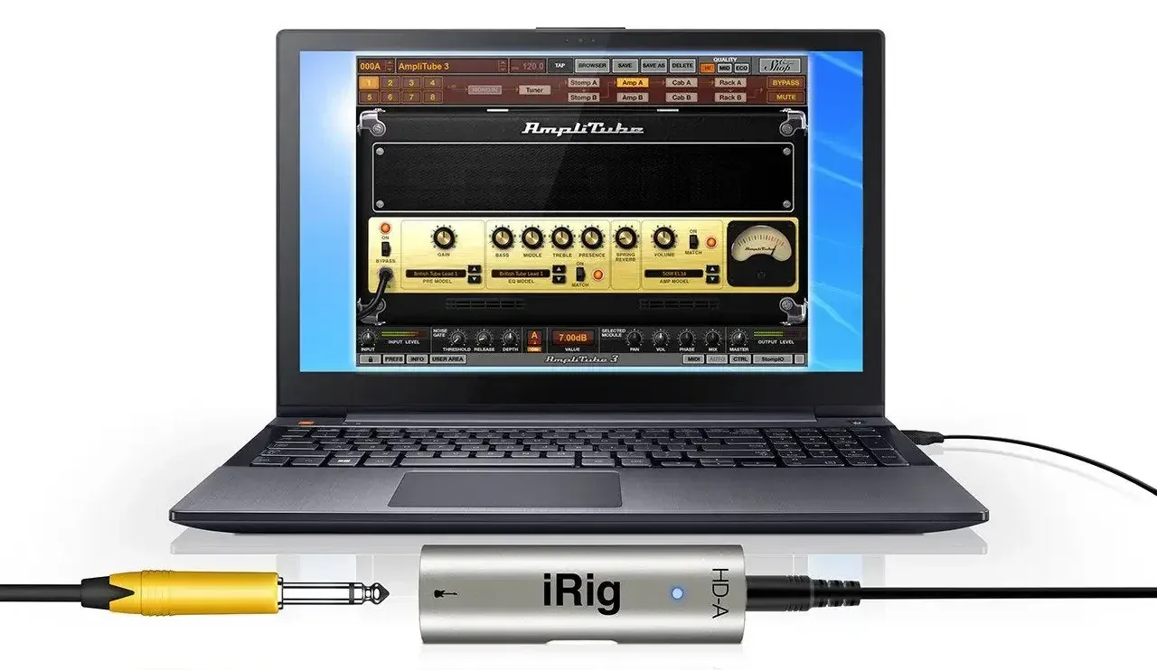 iRig HD-A audio interface connected to laptop displaying AmpliTube 3 guitar amp simulation software with yellow instrument cable attached
