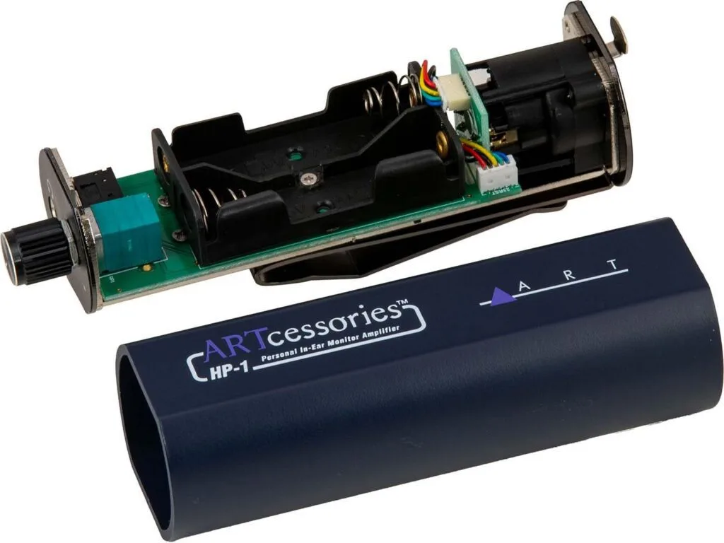 ART HP-1 personal monitor amplifier showing disassembled internal components with circuit board and battery compartment alongside dark blue