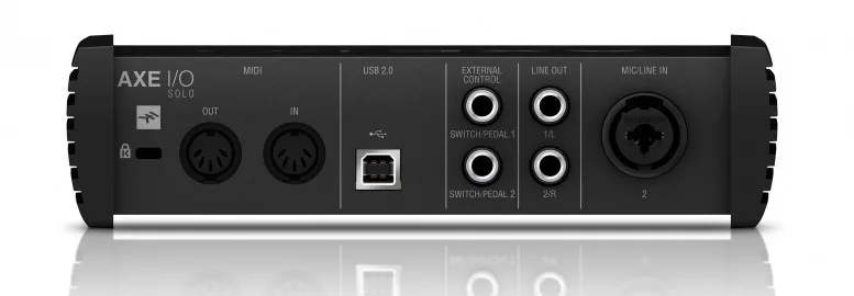 Behringer AXE I/O Solo audio interface, top-down view showing dual XLR outputs, USB connection, and mic input on black chassis