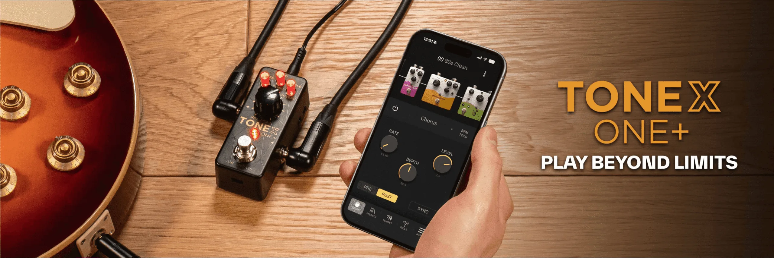 TONEX ONE+ compact effects pedal displayed on wooden surface next to red electric guitar and smartphone app interface