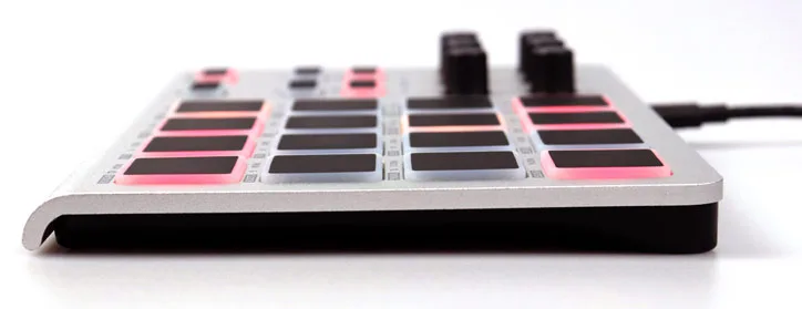 ESI Xjam controller angled view showing pink and black pad grid with two knobs, white background