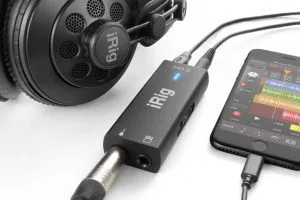 iRig HD2 audio interface with headphones and smartphone showing connected setup on white background