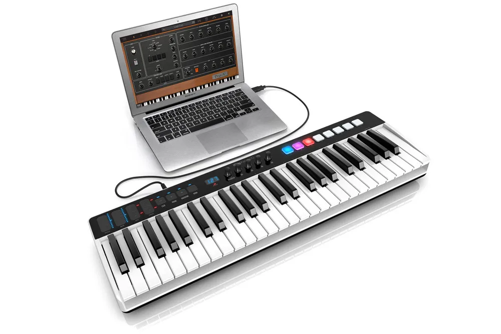 iRig Keys I/O keyboard controller connected to a laptop running music production software