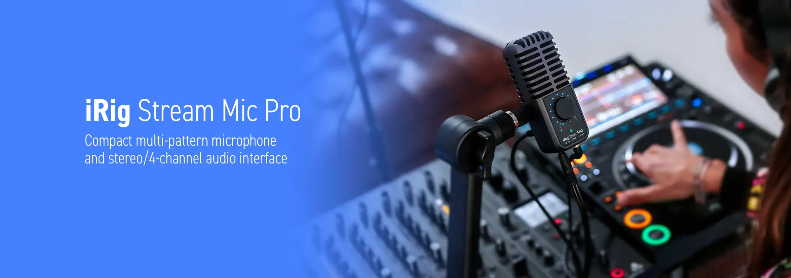 Black iRig Stream Mic Pro mounted on stand in front of DJ mixer and headphones, showing multi-pattern microphone design