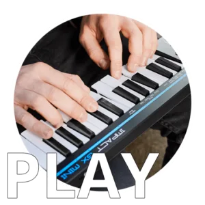 Hands playing a compact blue and black Nektar Impact GX Mini keyboard controller with keys visible