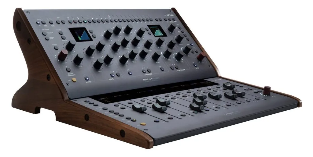 Console 1 Fader MKIII angled view showing gray face with dual small screens and faders, wooden base