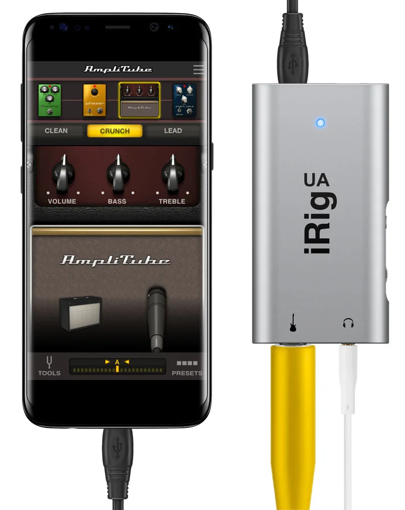 iRig UA audio interface in silver with yellow guitar cable, shown connected to smartphone displaying AmpliTube app interface