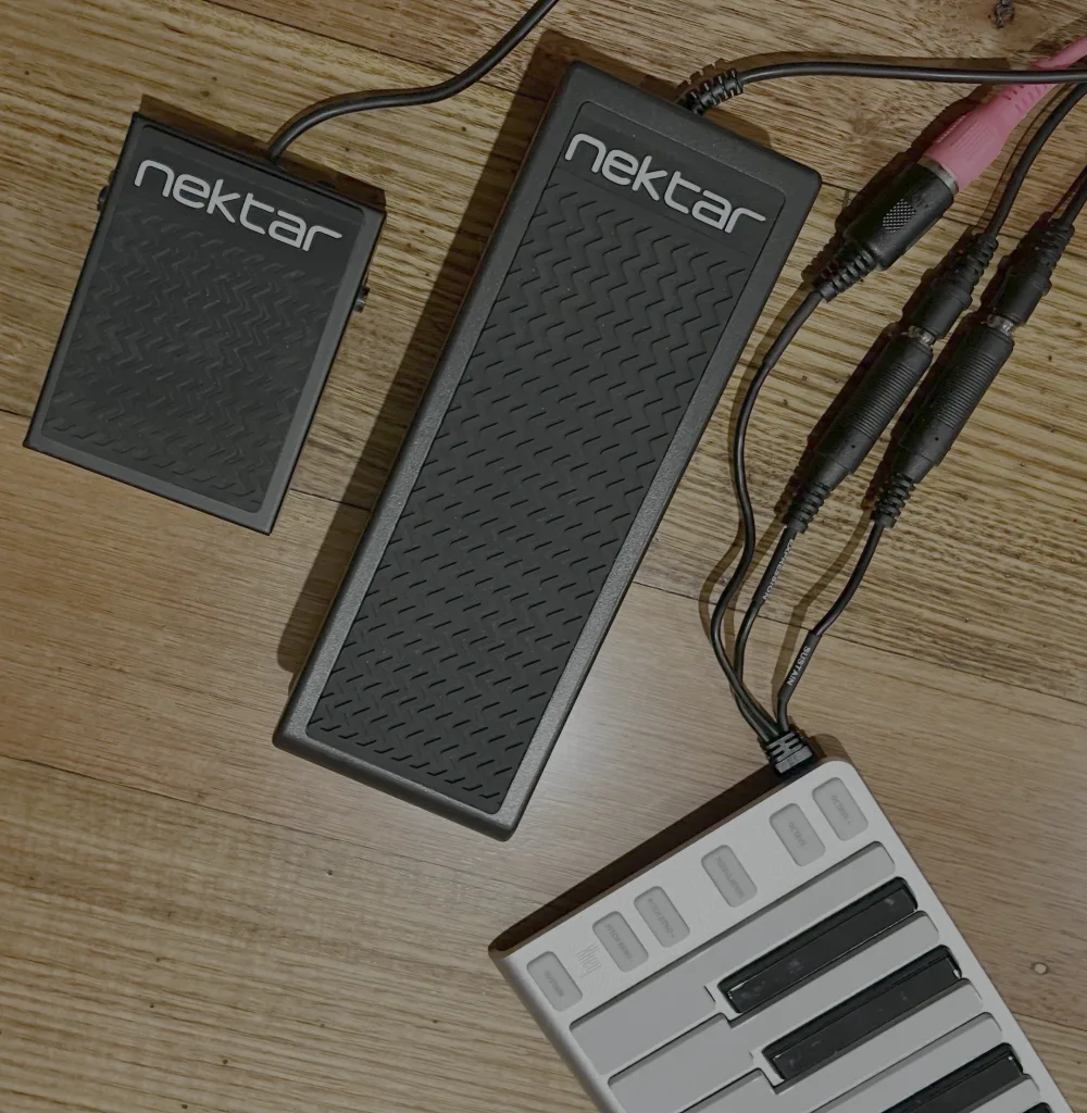 ESI Xkey 37 mini keyboard controller connected to Nektar pedals on wooden desk