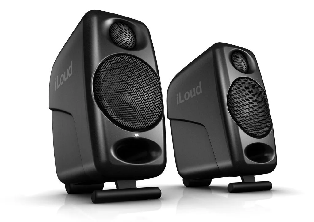 Two black iLoud compact studio monitors at an angle on white background, with mesh speaker cones and rubber feet visible.