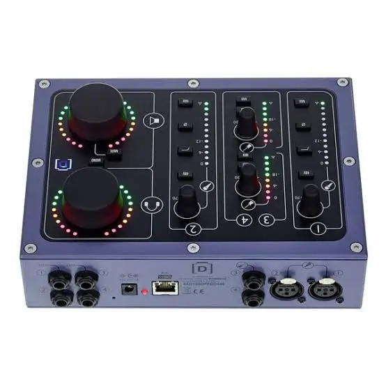 DiGiGrid D blue desktop audio interface with dual knobs and black faders against white background